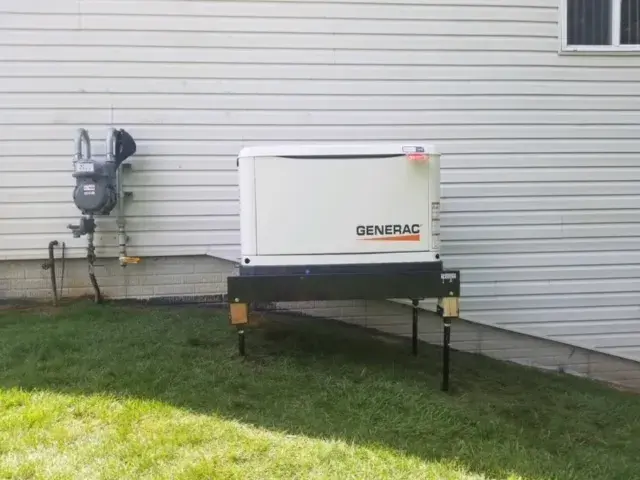 Residential generator unit installed on gravel pad