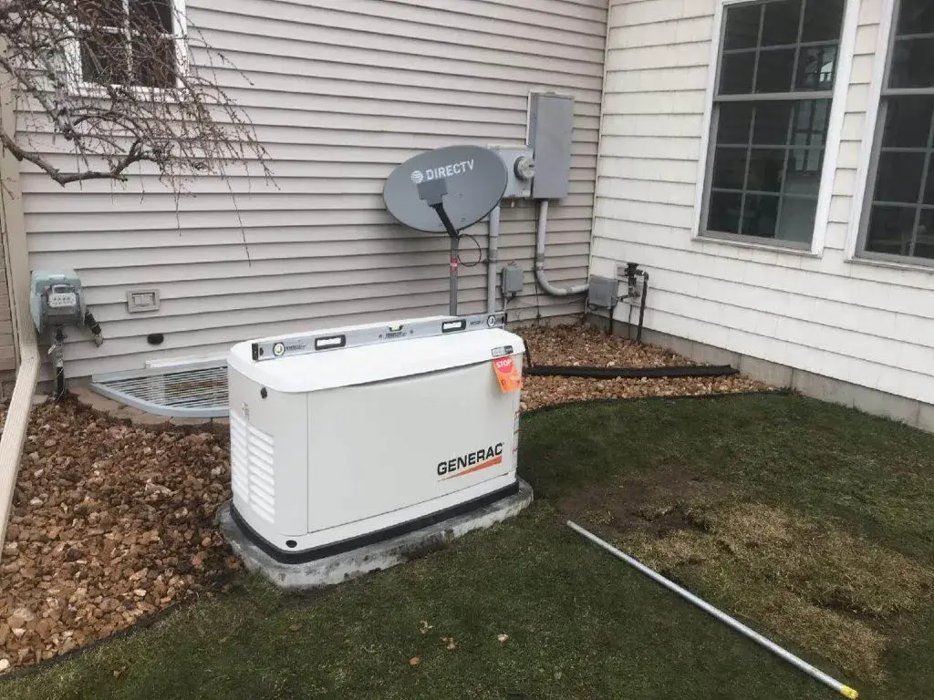 Generac generator beside home with utility connections complete