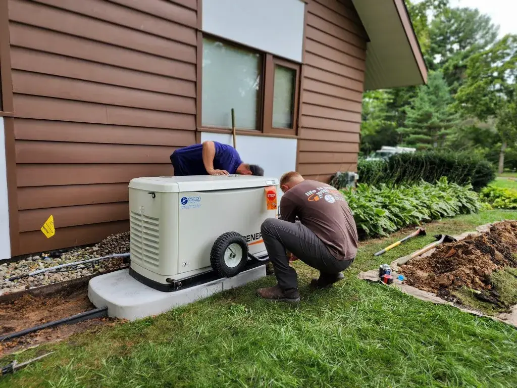 Residential Generac standby generator installed on concrete pad