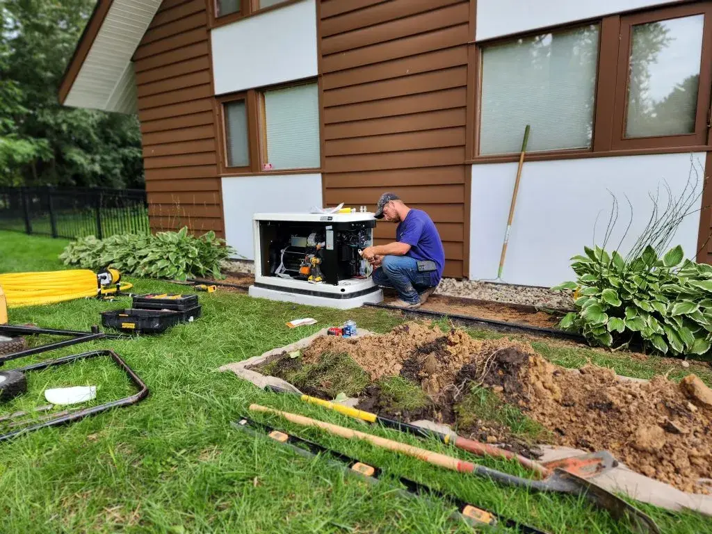 Generac generator installed beside home foundation