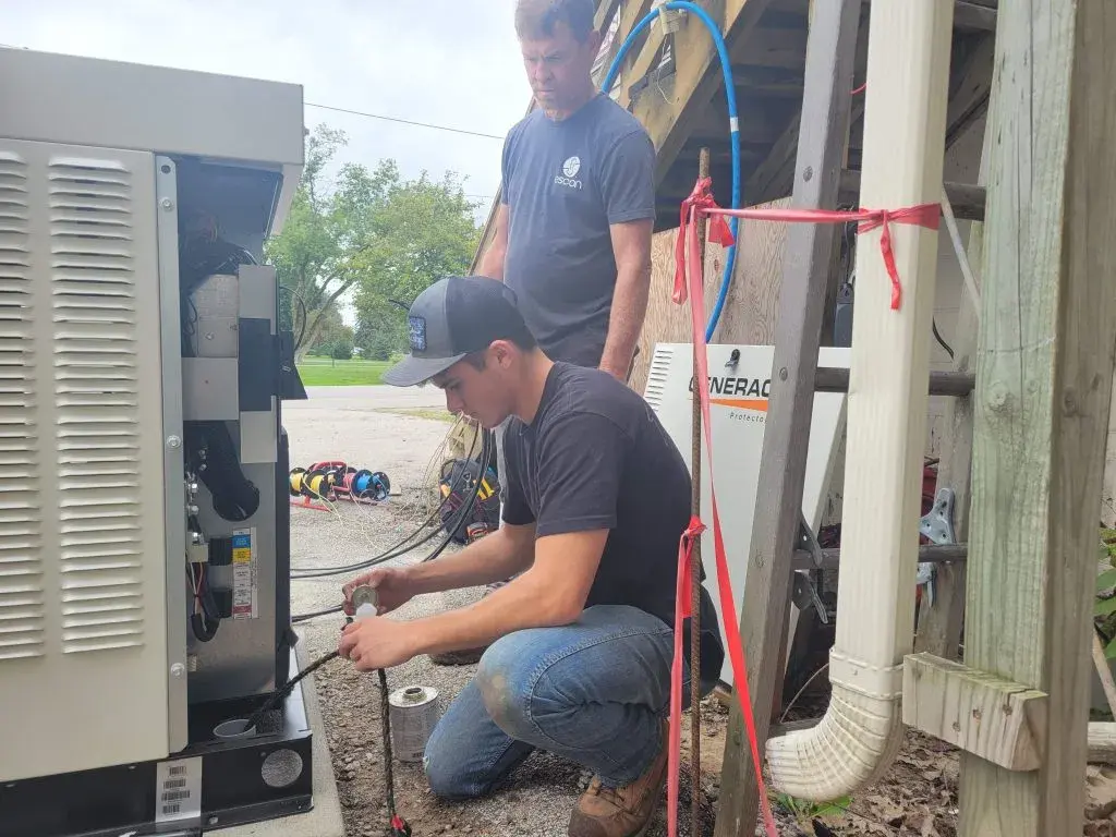 Generac generator on pad beside residential home